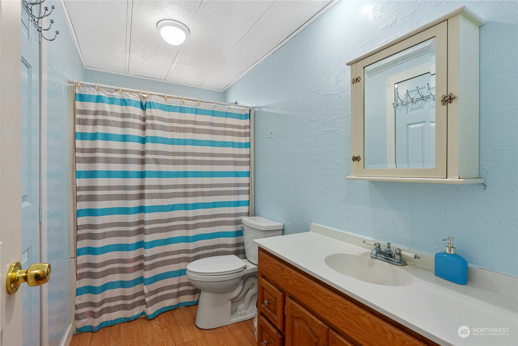 267 Limmer Road Winlock, WA 98596 - Photo 13 of 25 a bathroom with a sink a toilet and shower curtain