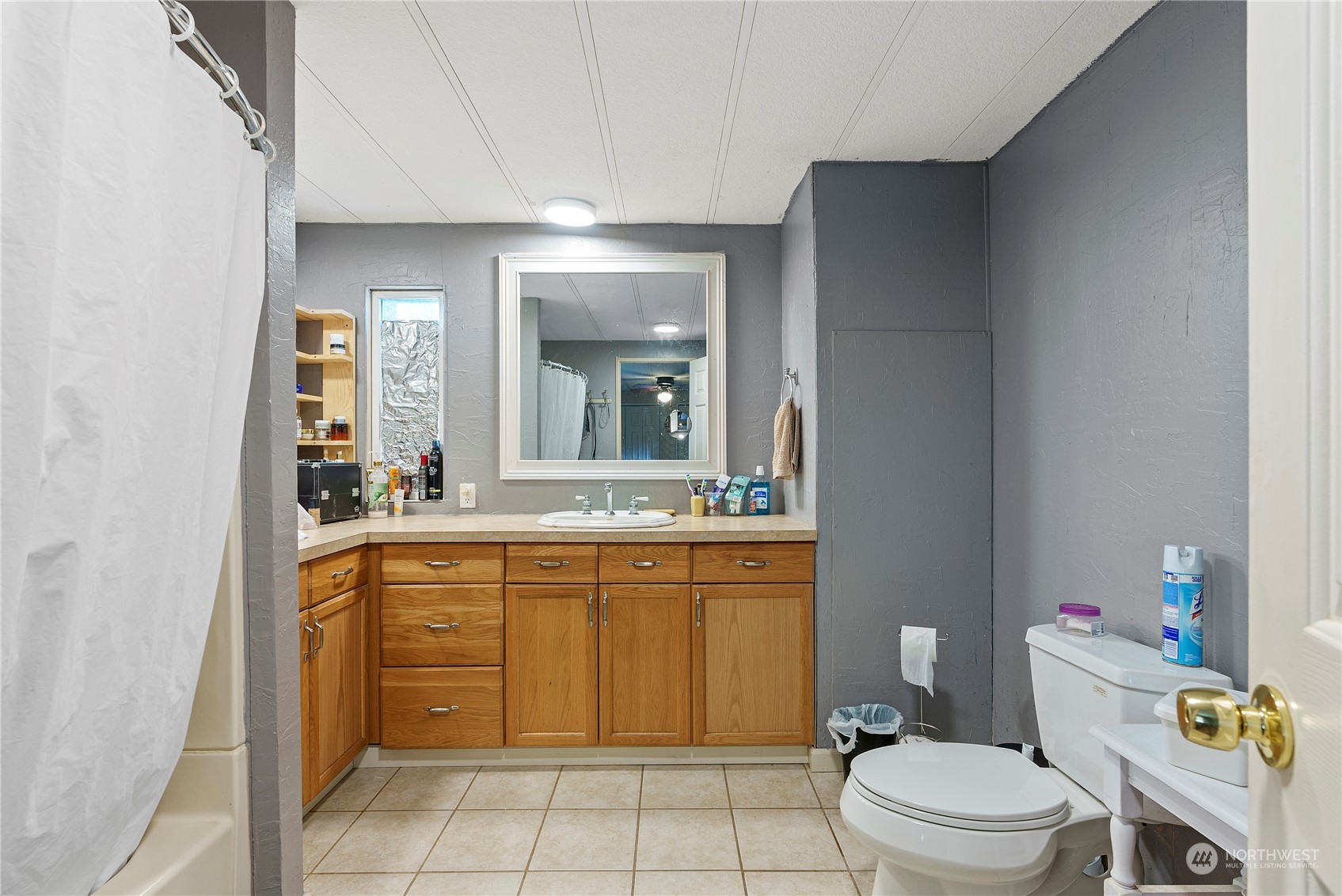 267 Limmer Road Winlock, WA 98596 - Photo 17 of 25 a spacious bathroom with a granite countertop toilet a sink and a mirror