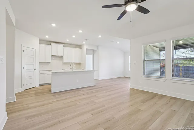 a view of kitchen with granite countertop cabinets and wooden floor