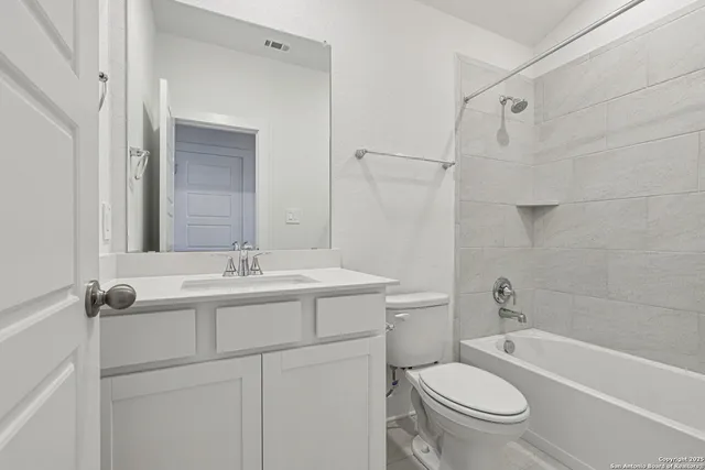 a bathroom with a sink toilet vanity and shower