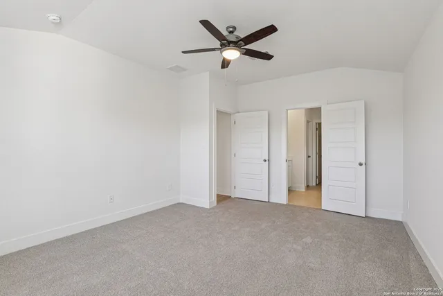 a bedroom with a balcony a bed and a flat screen television