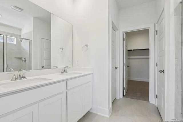 a bathroom with a sink double vanity and a mirror