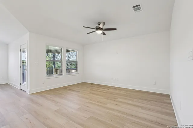 wooden floor in an empty room with a window