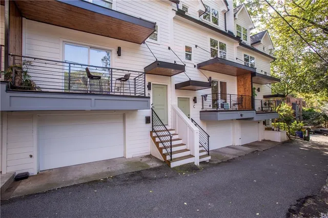 a view of a house with a garage and balcony