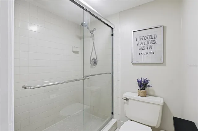 a bathroom with a shower a toilet and a sink