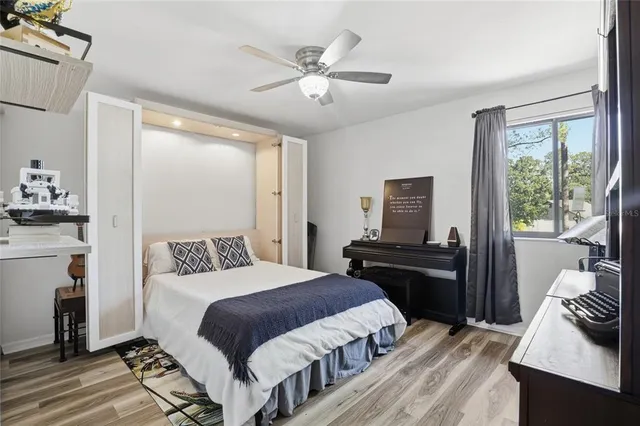 a bedroom with a bed and wooden floor