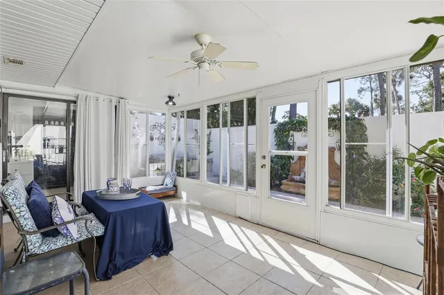 a living room with furniture and a floor to ceiling window