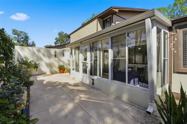 a view of a patio with table and chairs and potted plants
