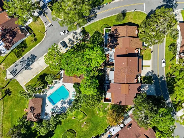 a view of a porch with chairs and potted plants
