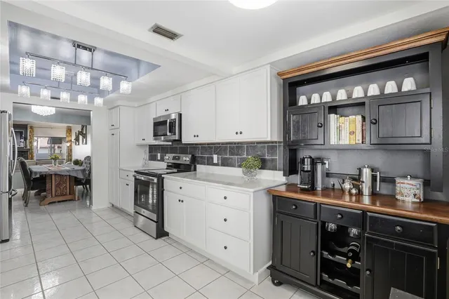 a kitchen with stainless steel appliances granite countertop a stove and cabinets