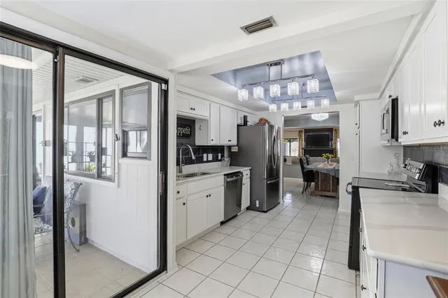a kitchen with refrigerator and cabinets