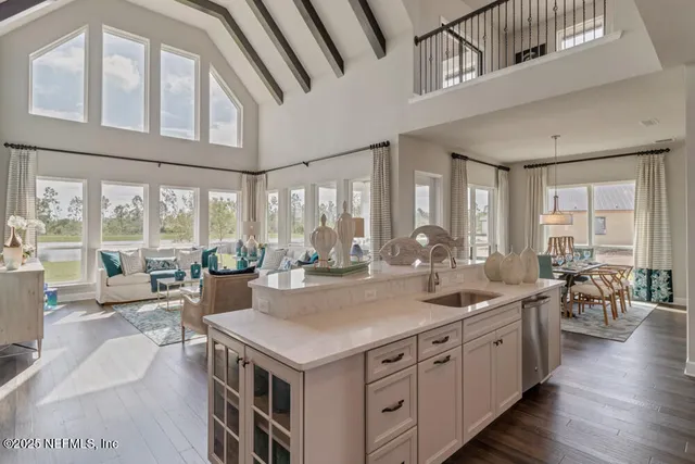 a view of a kitchen counter top space with furniture and wooden floor