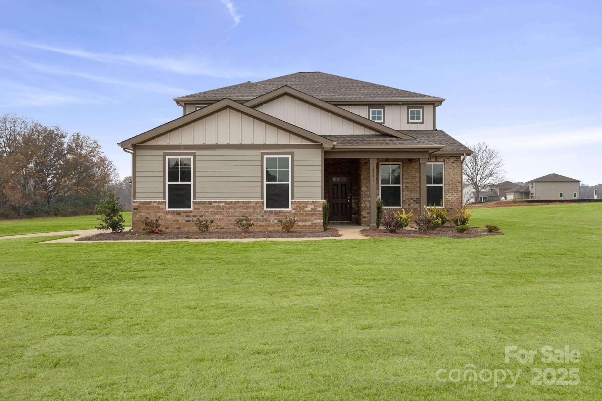 a front view of house with yard and green space