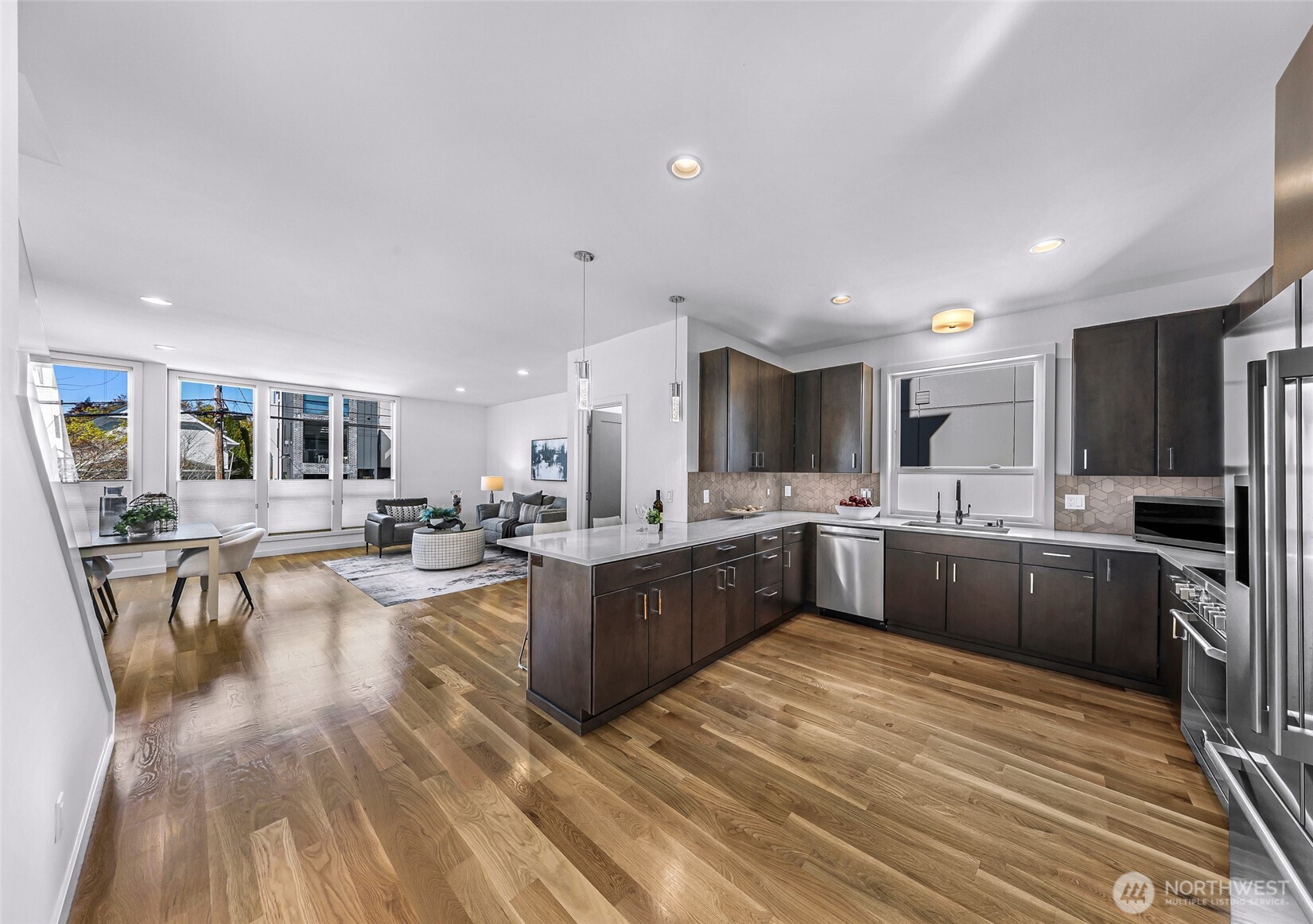 4218 Linden Avenue North Seattle, WA 98103 - Photo 11 of 38 a large kitchen with lots of counter space and stainless steel appliances