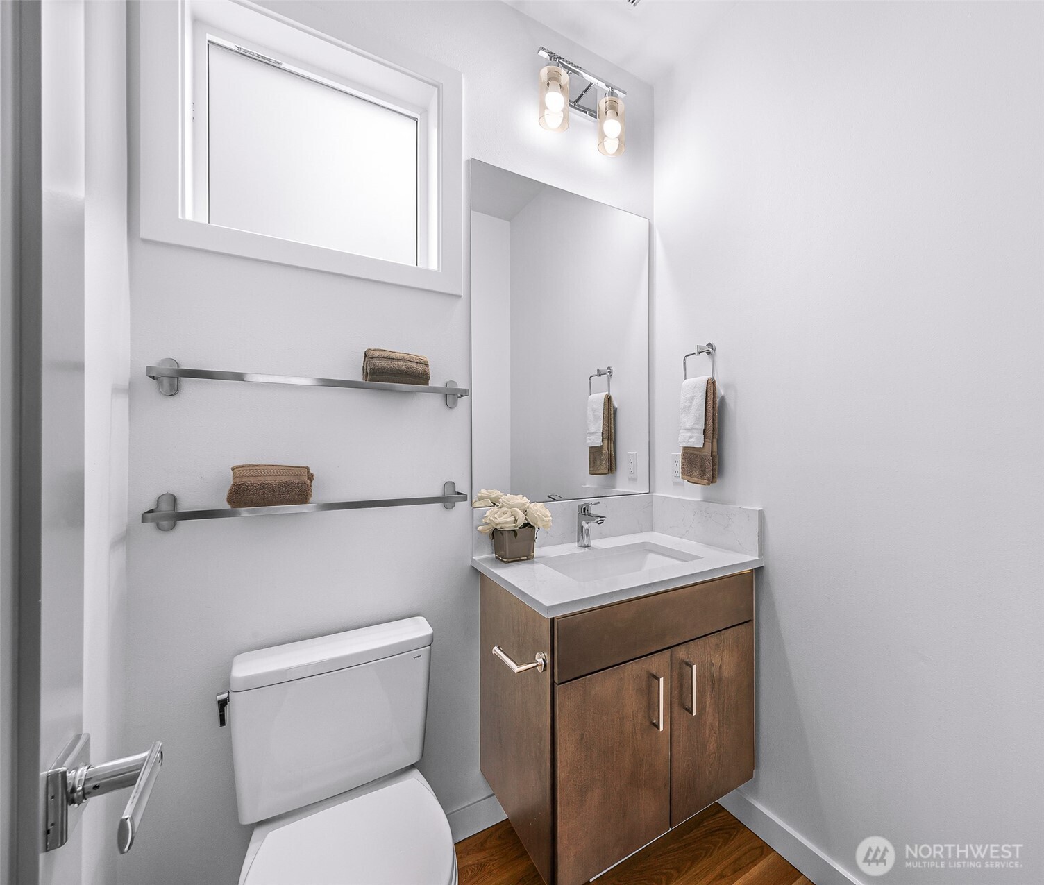 4218 Linden Avenue North Seattle, WA 98103 - Photo 15 of 38 a bathroom with a toilet sink vanity and mirror