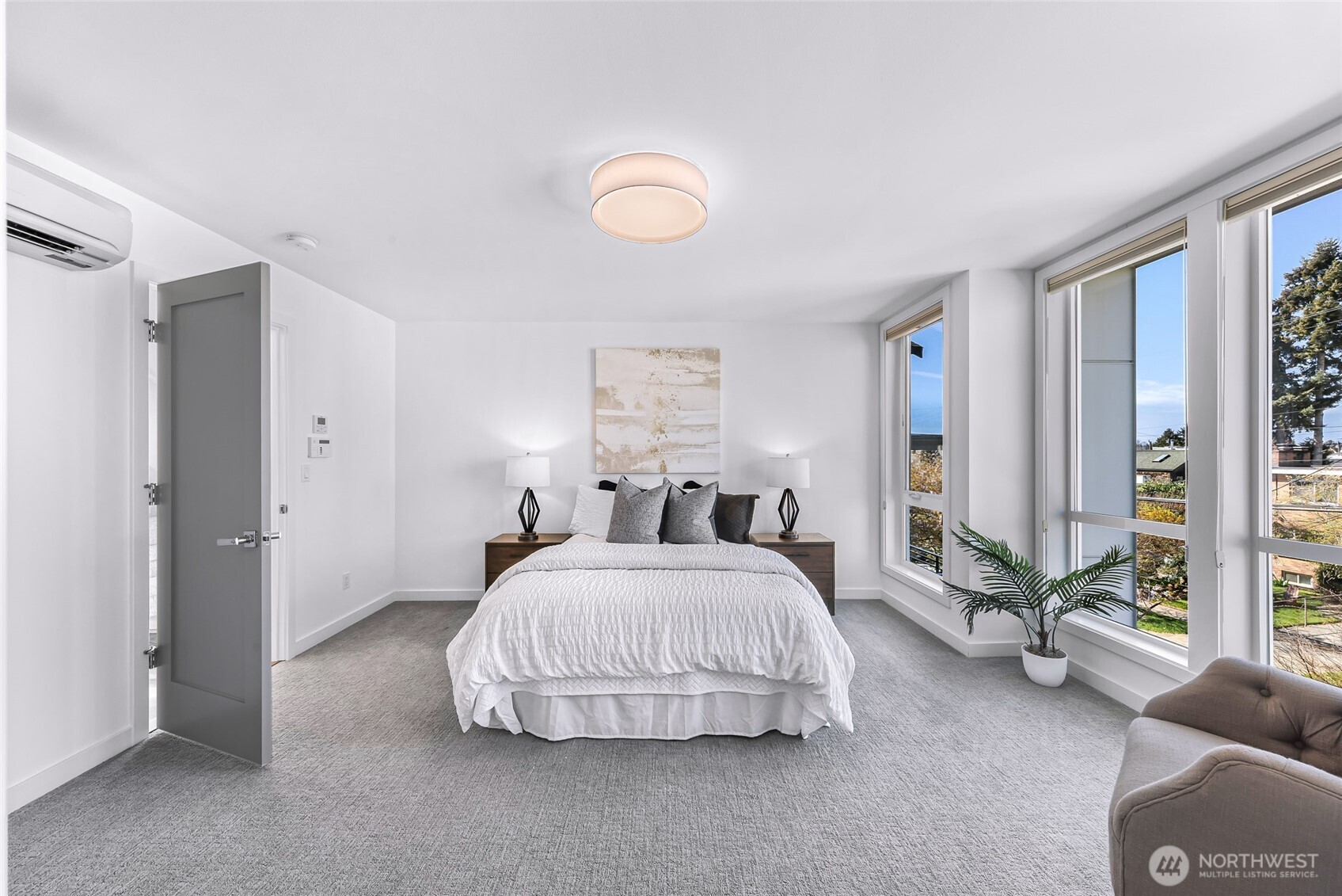 4218 Linden Avenue North Seattle, WA 98103 - Photo 19 of 38 a spacious bedroom with a bed and large windows