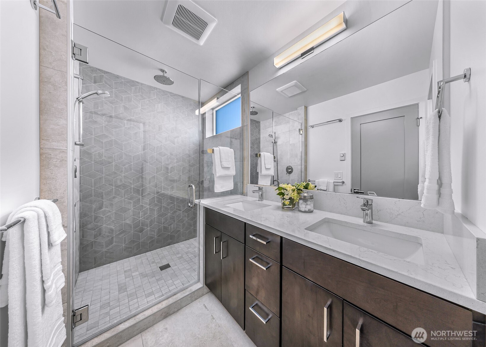 4218 Linden Avenue North Seattle, WA 98103 - Photo 20 of 38 a bathroom with a double vanity sink mirror double and shower