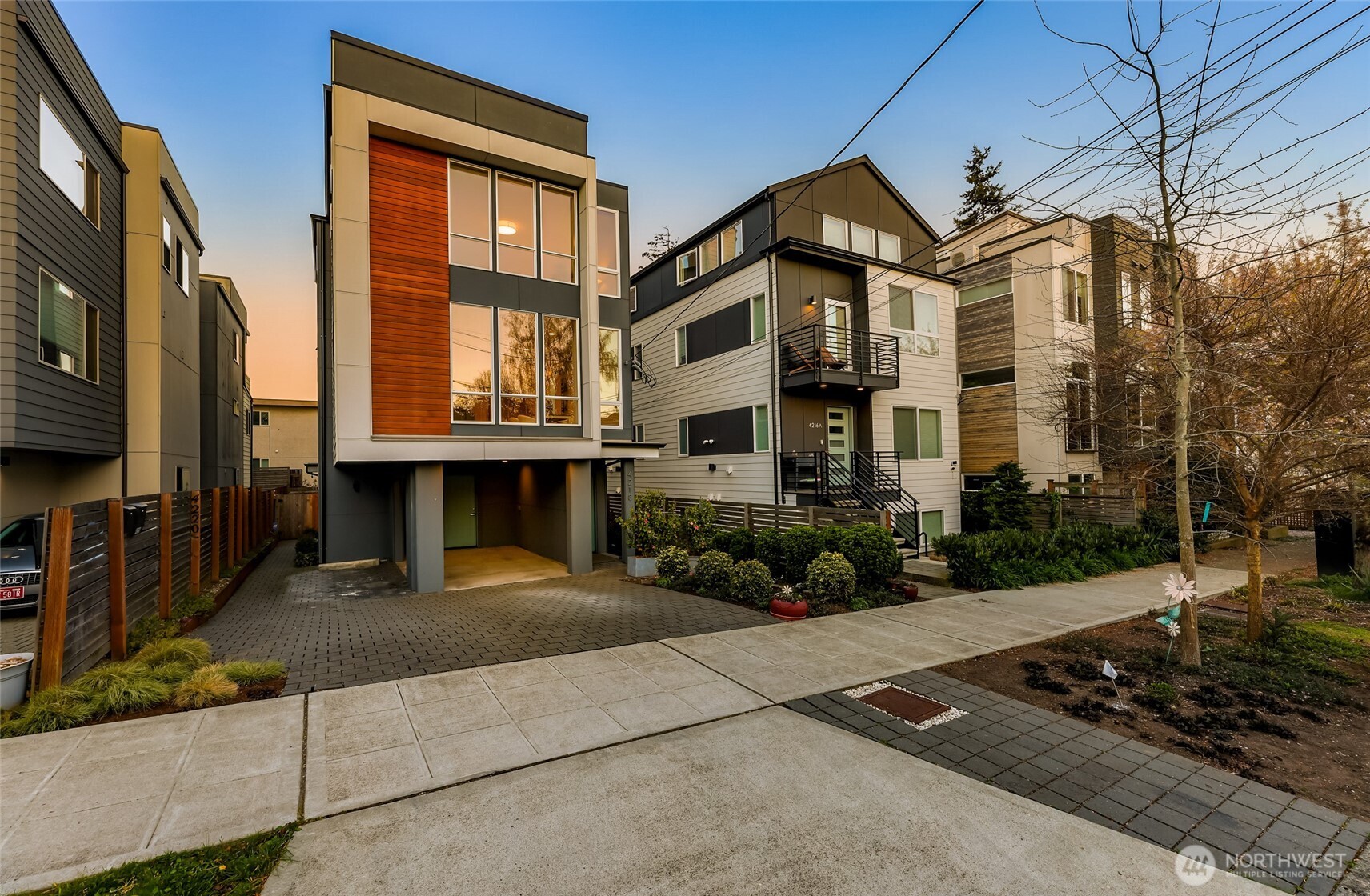 4218 Linden Avenue North Seattle, WA 98103 - Photo 2 of 38 a front view of a residential apartment building with a yard