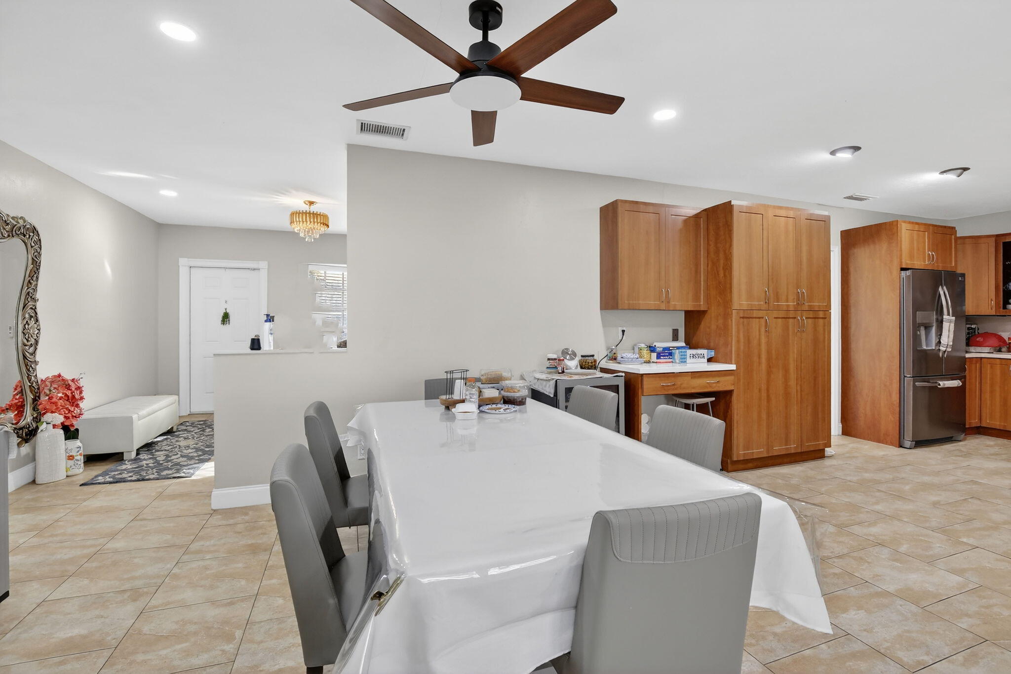 5507 McKinley Street Hollywood, FL 33021 - Photo 18 of 60 a kitchen with stainless steel appliances kitchen island granite countertop a refrigerator a sink a stove with white cabinets and wooden floor