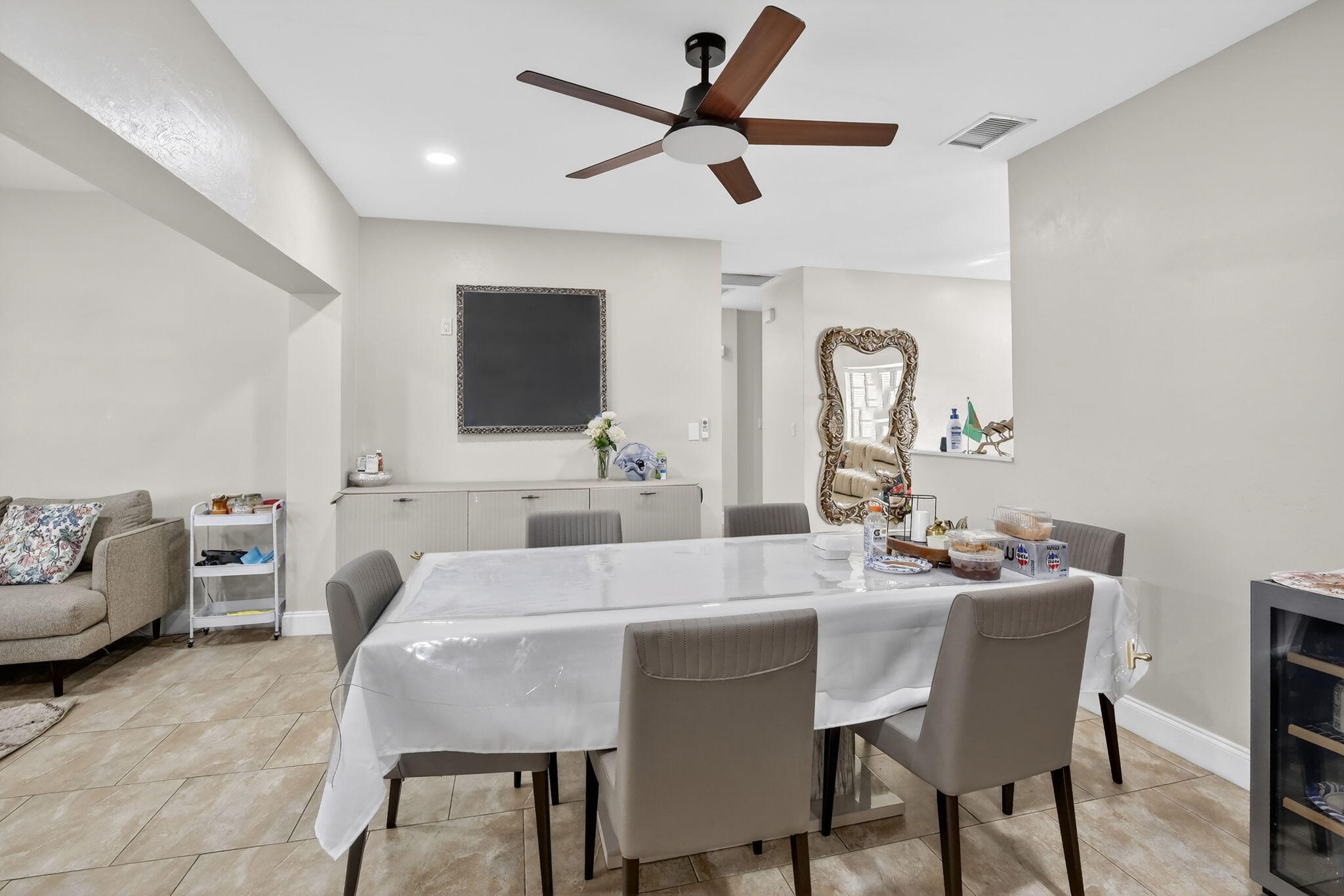 5507 McKinley Street Hollywood, FL 33021 - Photo 19 of 60 a dining room with furniture and a chandelier fan