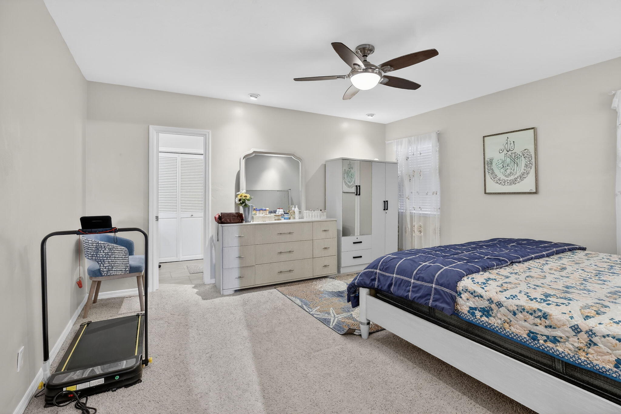 5507 McKinley Street Hollywood, FL 33021 - Photo 36 of 60 a bedroom with a bed and a chandelier