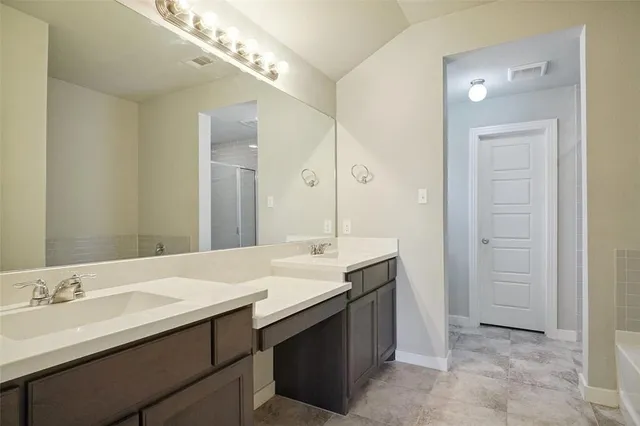 a bathroom with a sink double vanity and a mirror