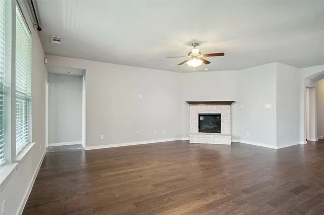 wooden floor chandelier and windows in an empty room