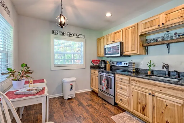 a kitchen with sink cabinets and wooden floor