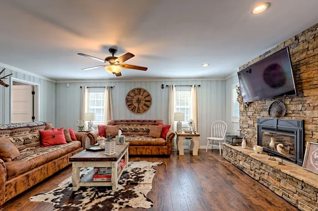a living room with furniture and wooden floor
