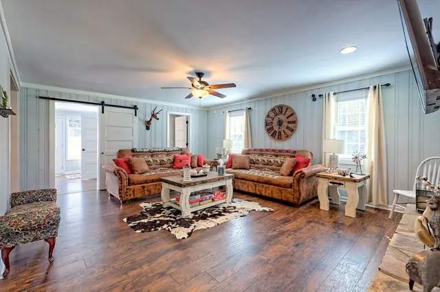 a living room with furniture a rug and a window