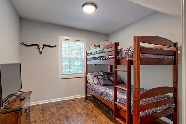 a bedroom with furniture and a wooden floor