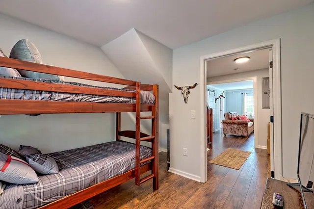 a view of a hallway with wooden floor and a chandelier