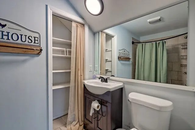 a bathroom with a tub shower and sink