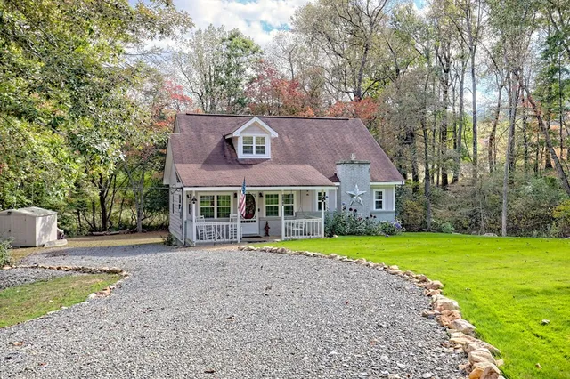 a front view of house with yard and green space