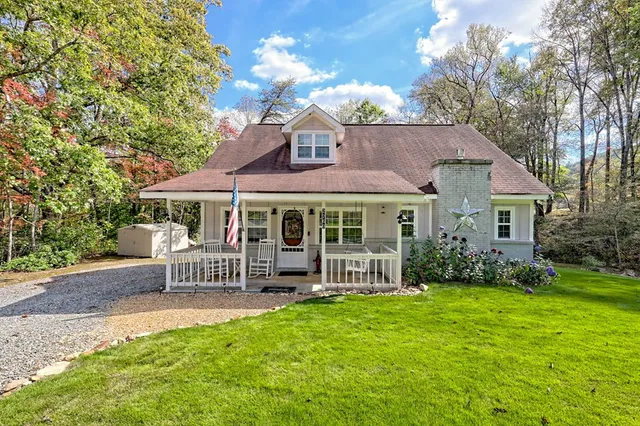 a view of a porch with a table and chairs