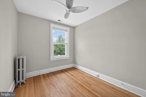 an empty room with closet and wooden floor