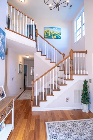 a view of entryway and hall with wooden floor