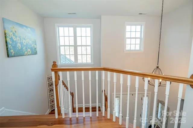 a bedroom with bed and a chandelier