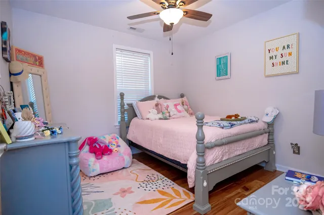 a bed room with a bed and a chair