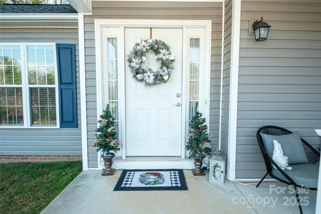 a view of a door and chair in back of the house