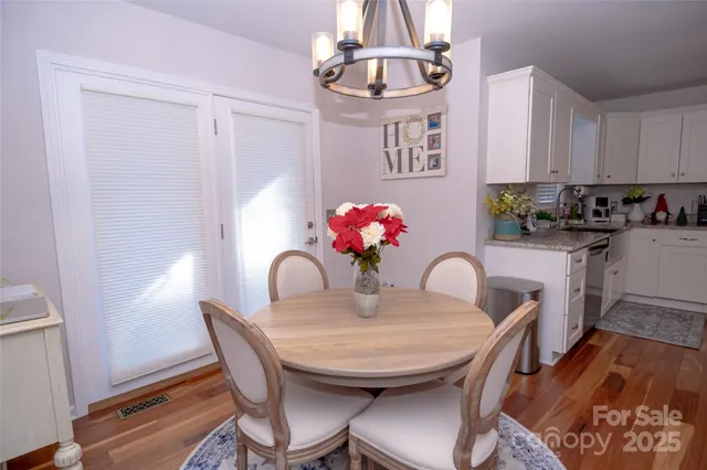 a dining room with furniture and wooden floor