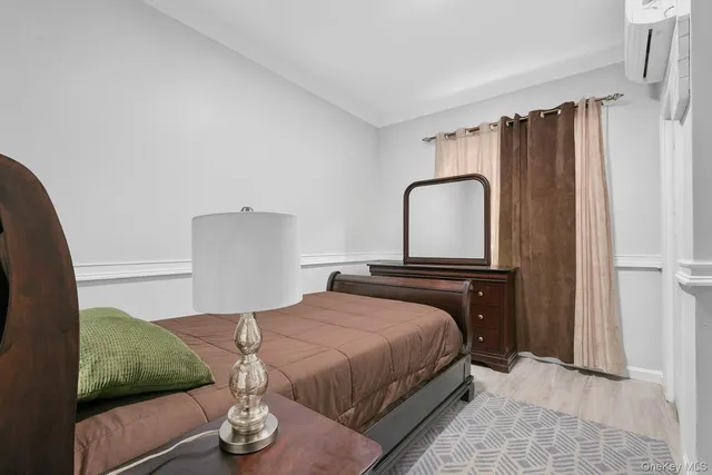 a bedroom with a bed and a potted plant