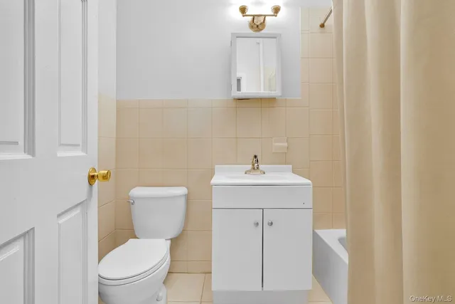 a white toilet sitting next to a bathroom sink