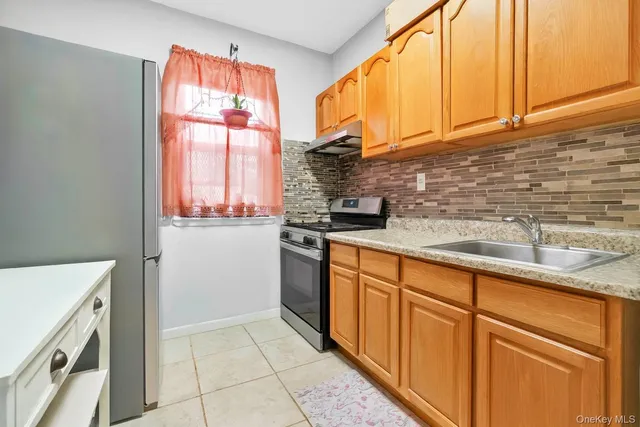 a kitchen with stainless steel appliances granite countertop a sink a stove and a microwave