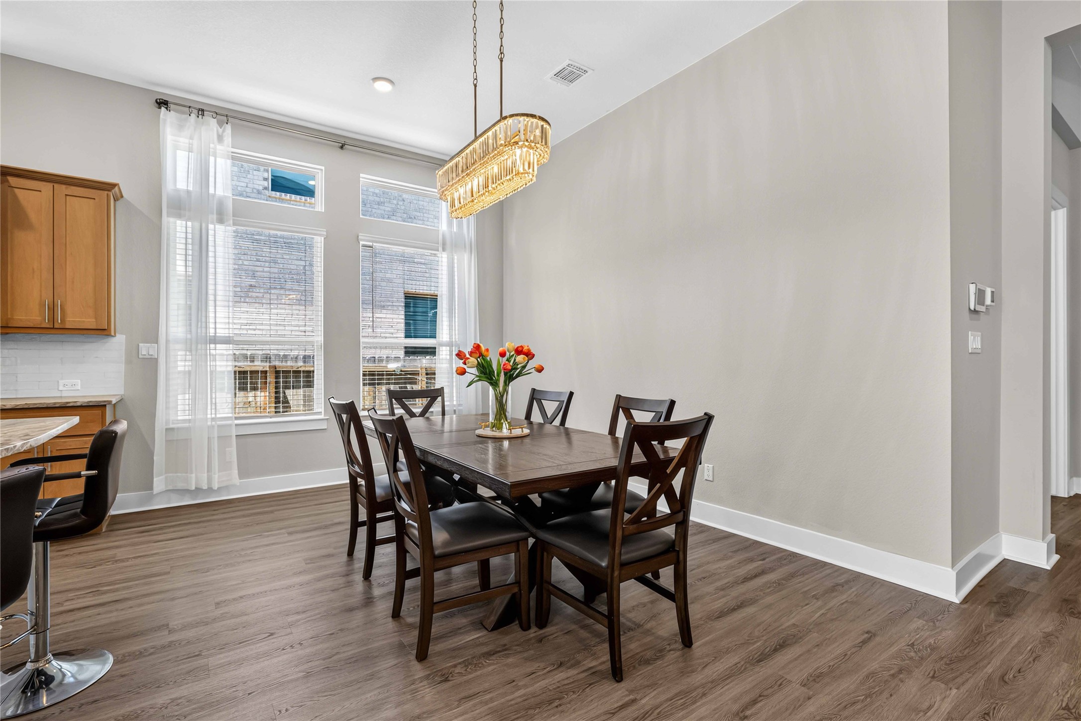 605 A Mallow Road Leander, TX 78641 - Photo 9 of 29 An inviting dining area features ample natural light and a dazzling overhead chandelier.