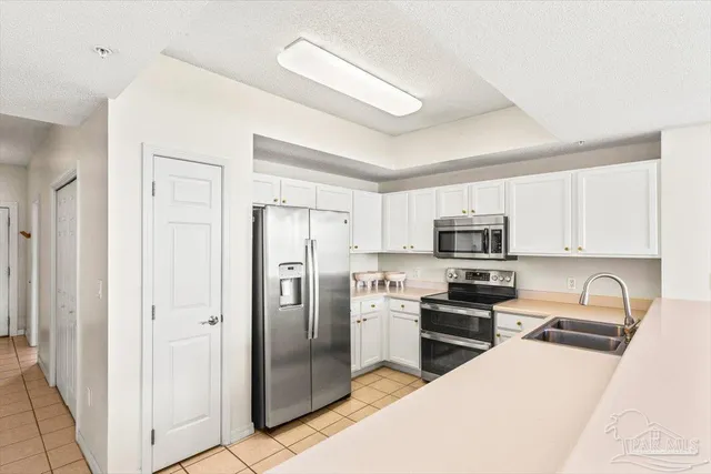 a kitchen with a sink and a refrigerator