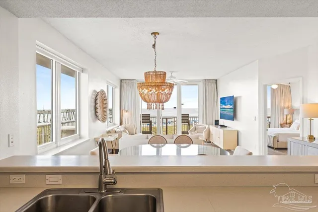 a large white kitchen with white cabinets and stainless steel appliances