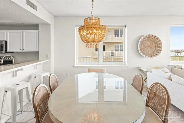 a living room with furniture a large window and a chandelier