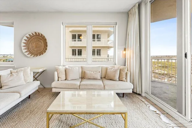 a living room with fireplace furniture and a large window