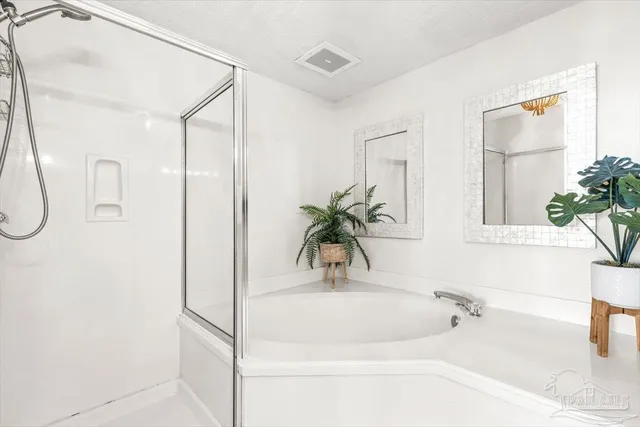 a bathroom with double sink and a mirror